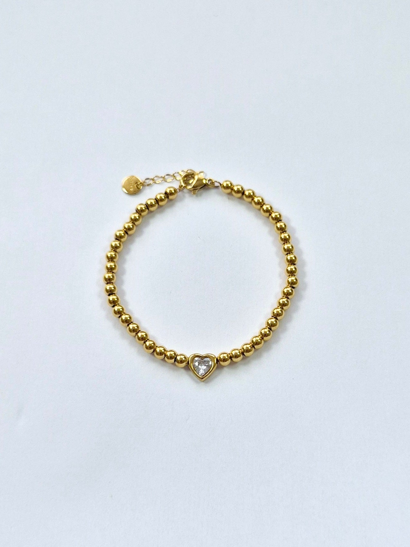 Bracelet perles dorées petit coeur